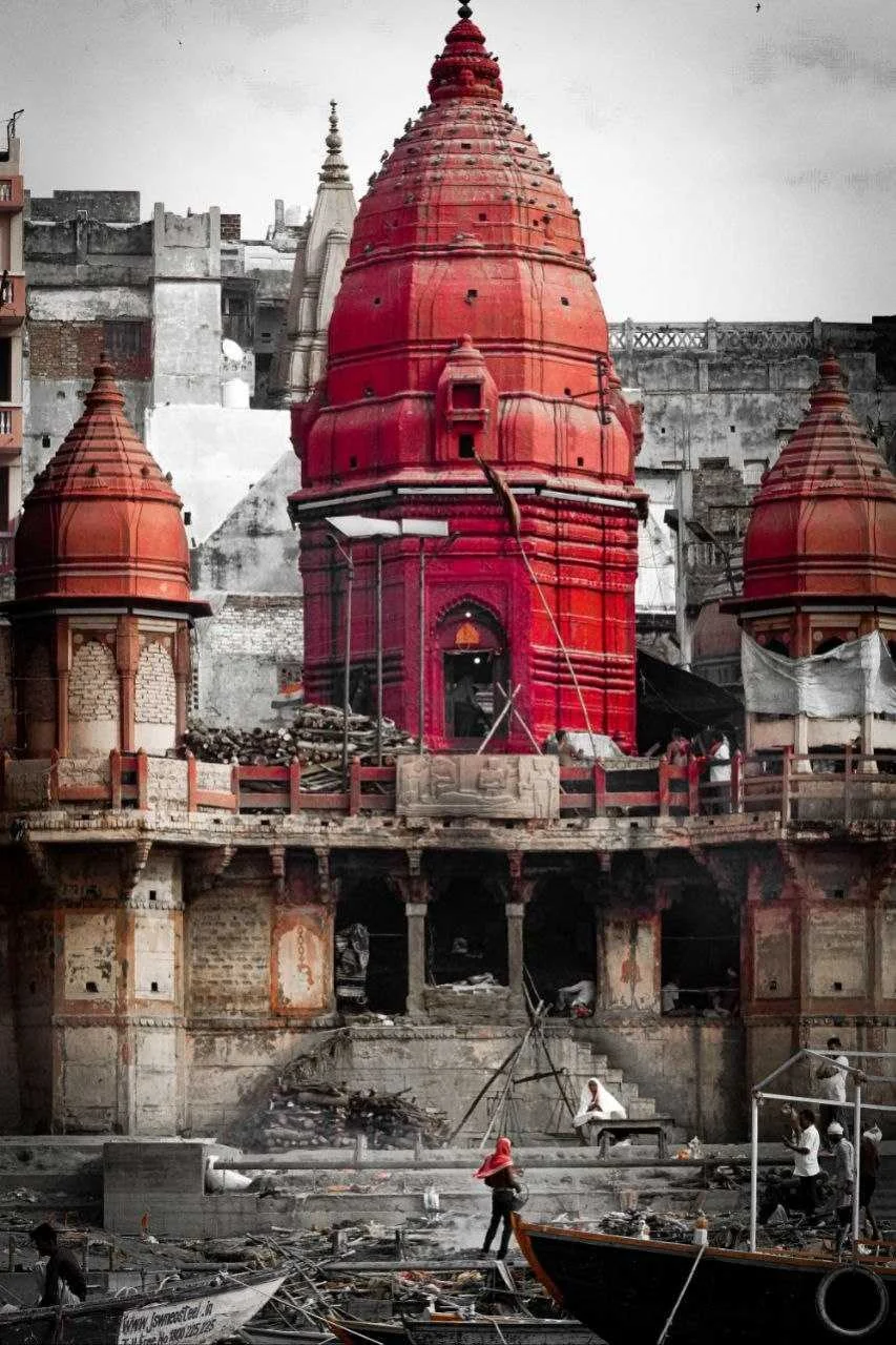 A red-domed building and people along the waterfront